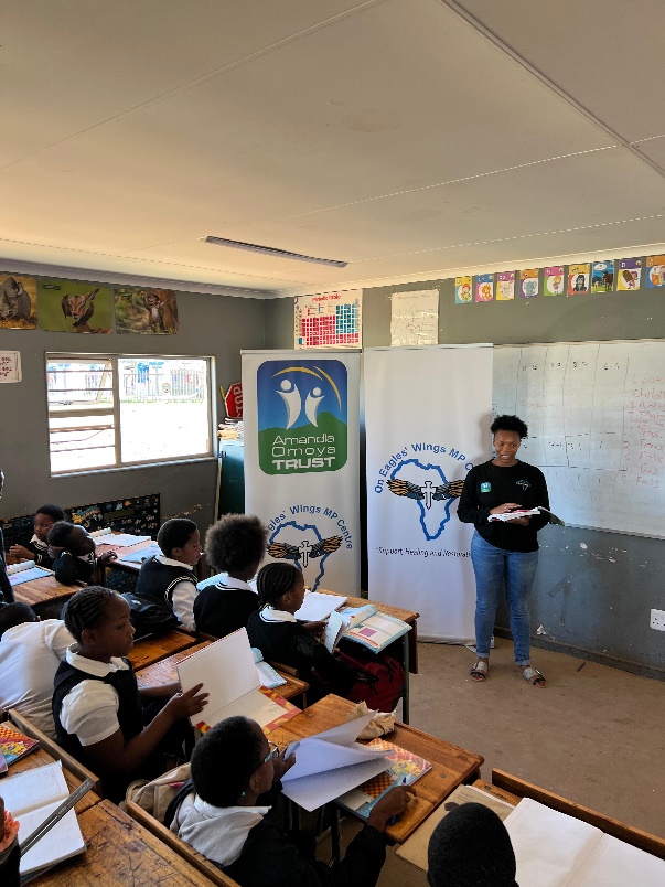 An On Eagle's Wings tutor with learners in a classroom